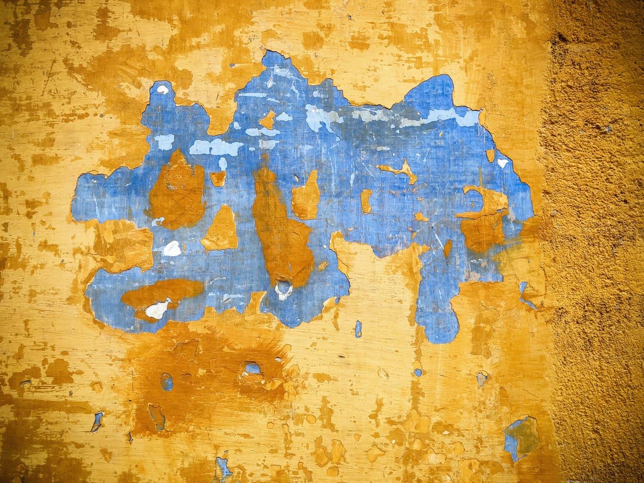 A blue patch on an ochre wall