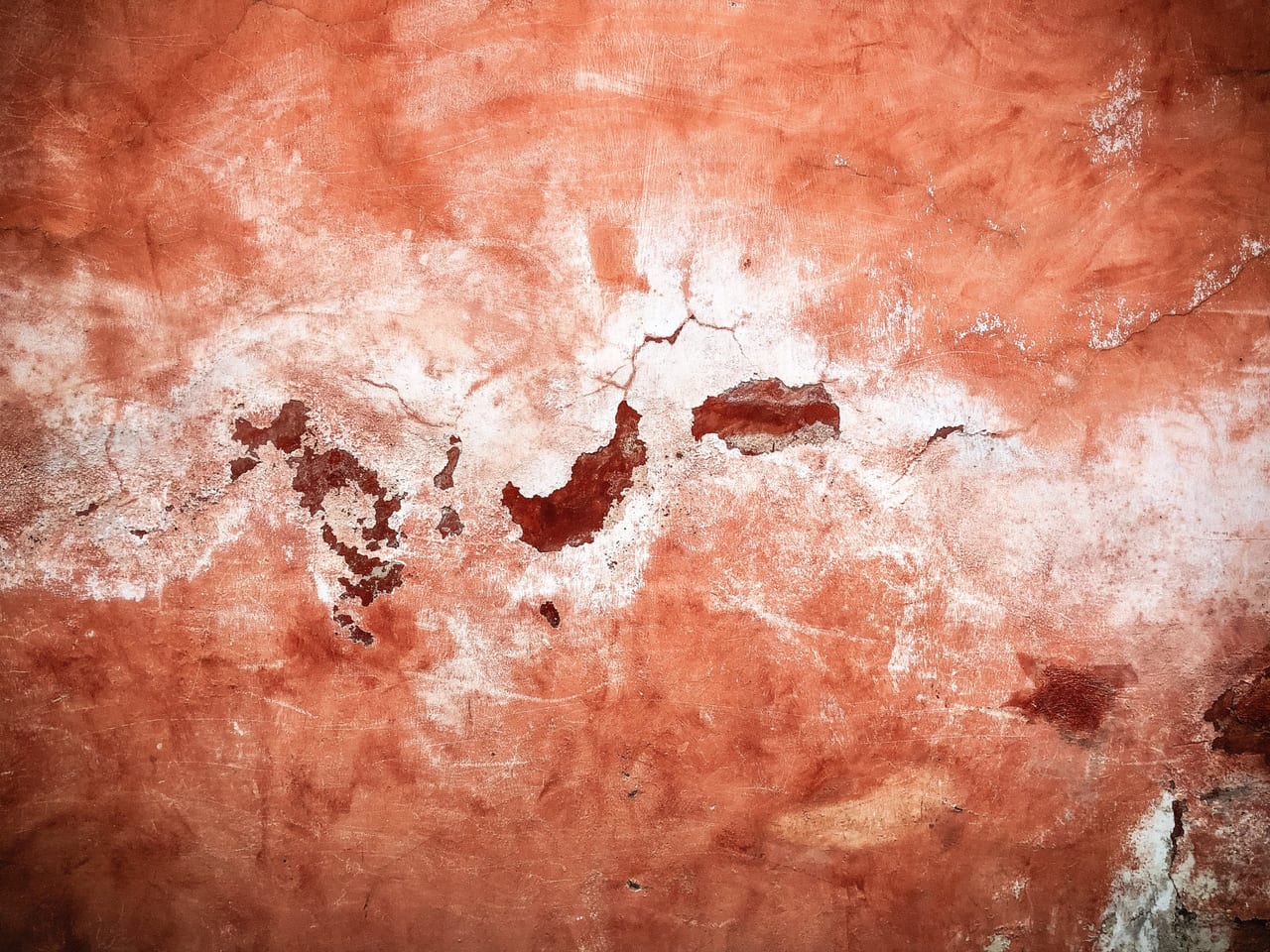 Terracotta plaster, cracked and flaking