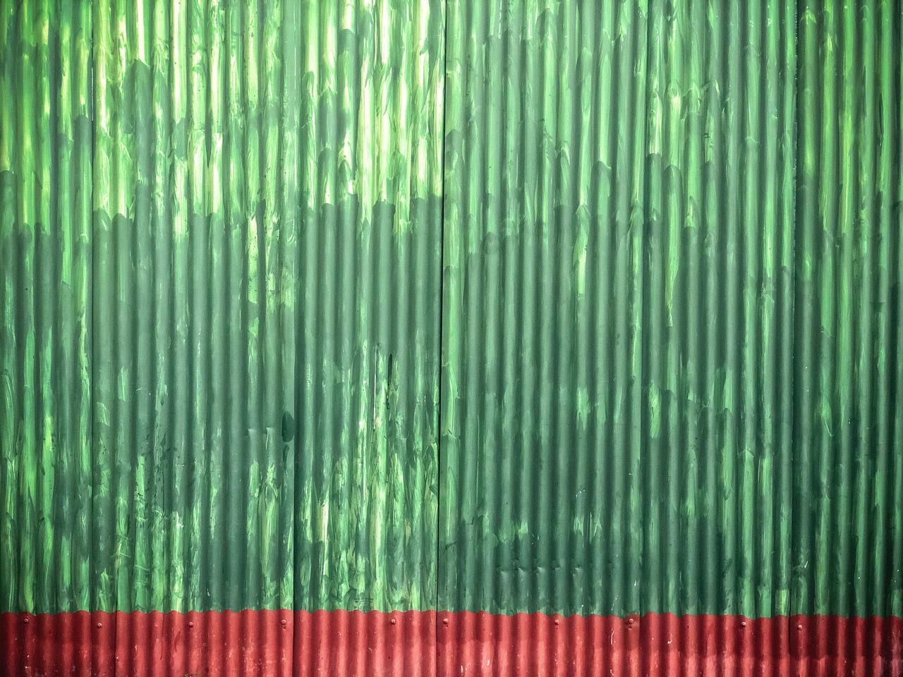 Green corrugated metal above a red edge