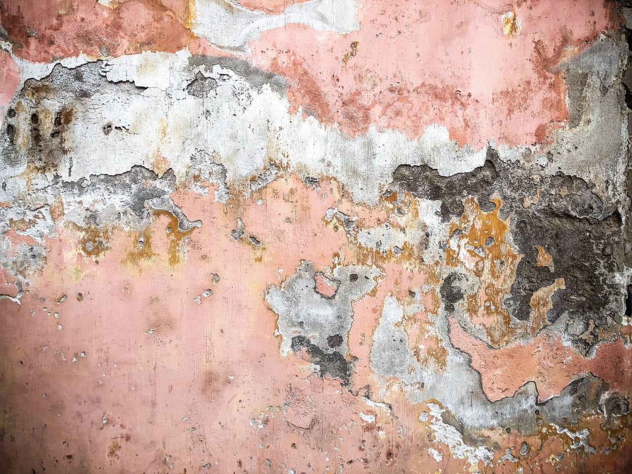 Pink plaster peeling in layers