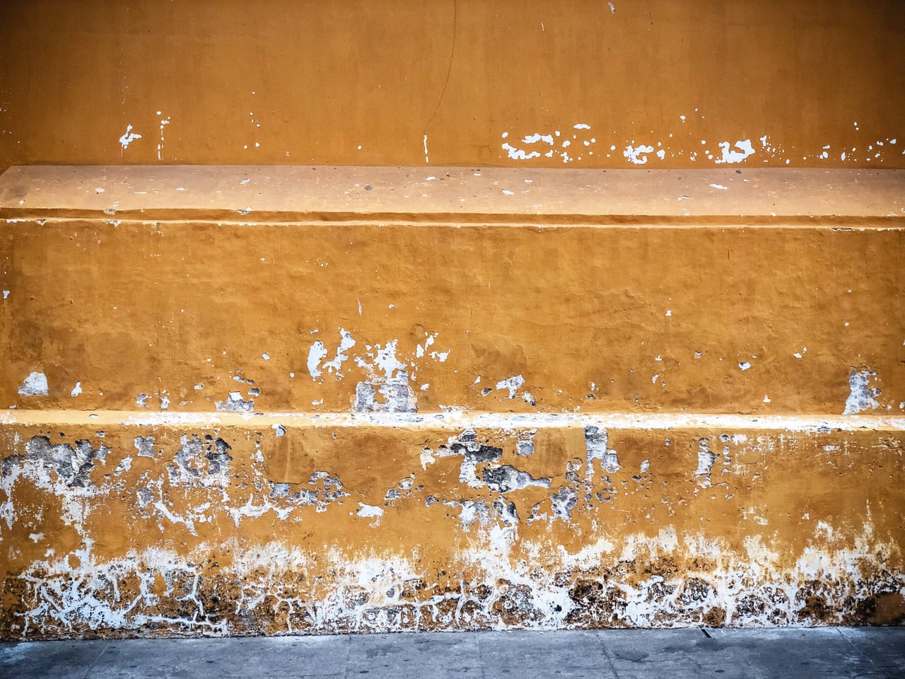 Stripes of ochre paint chipped away