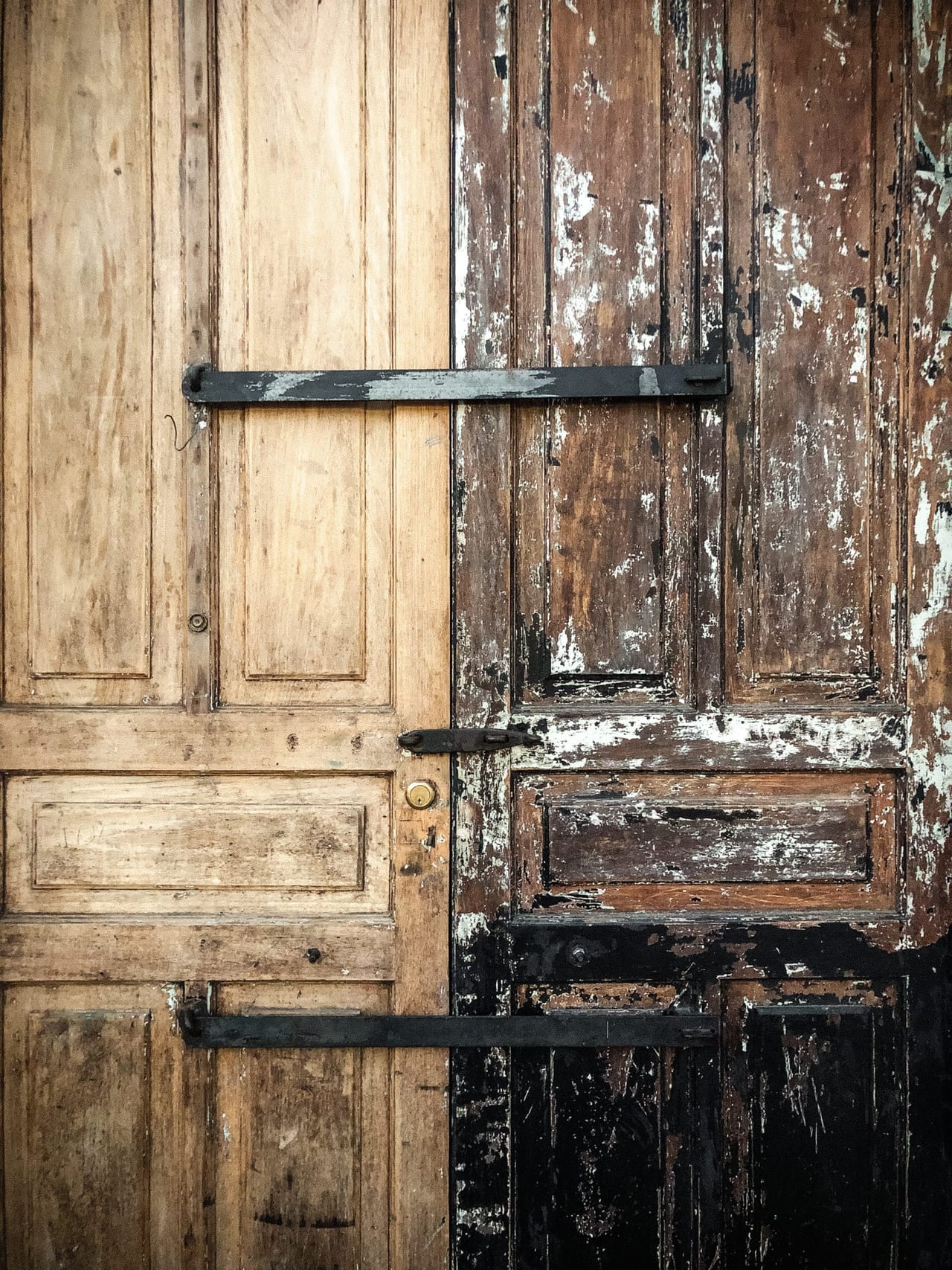 A door half pale wood, half dark